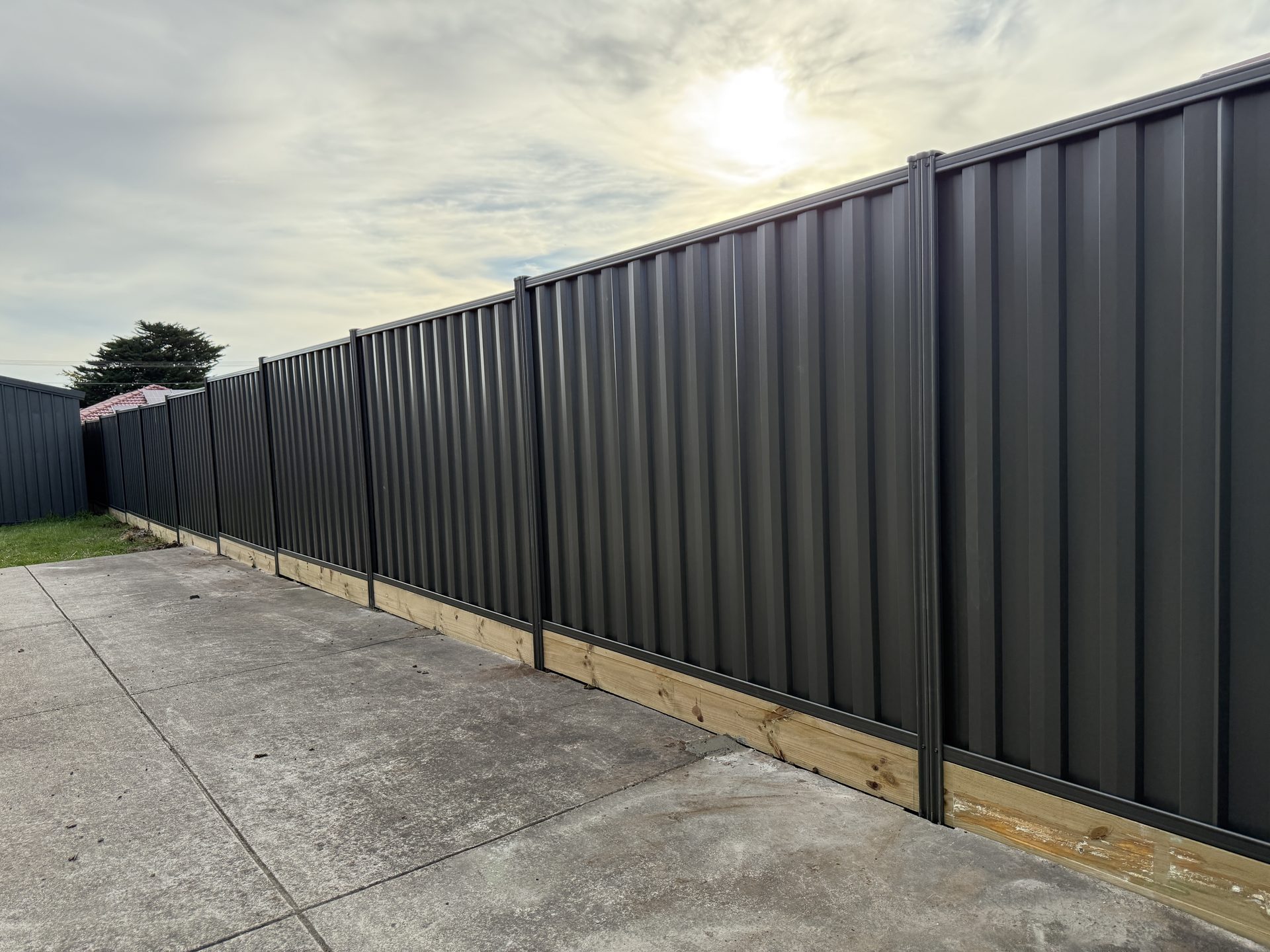 Grey Colorbond fence with garden bed, Melbourne