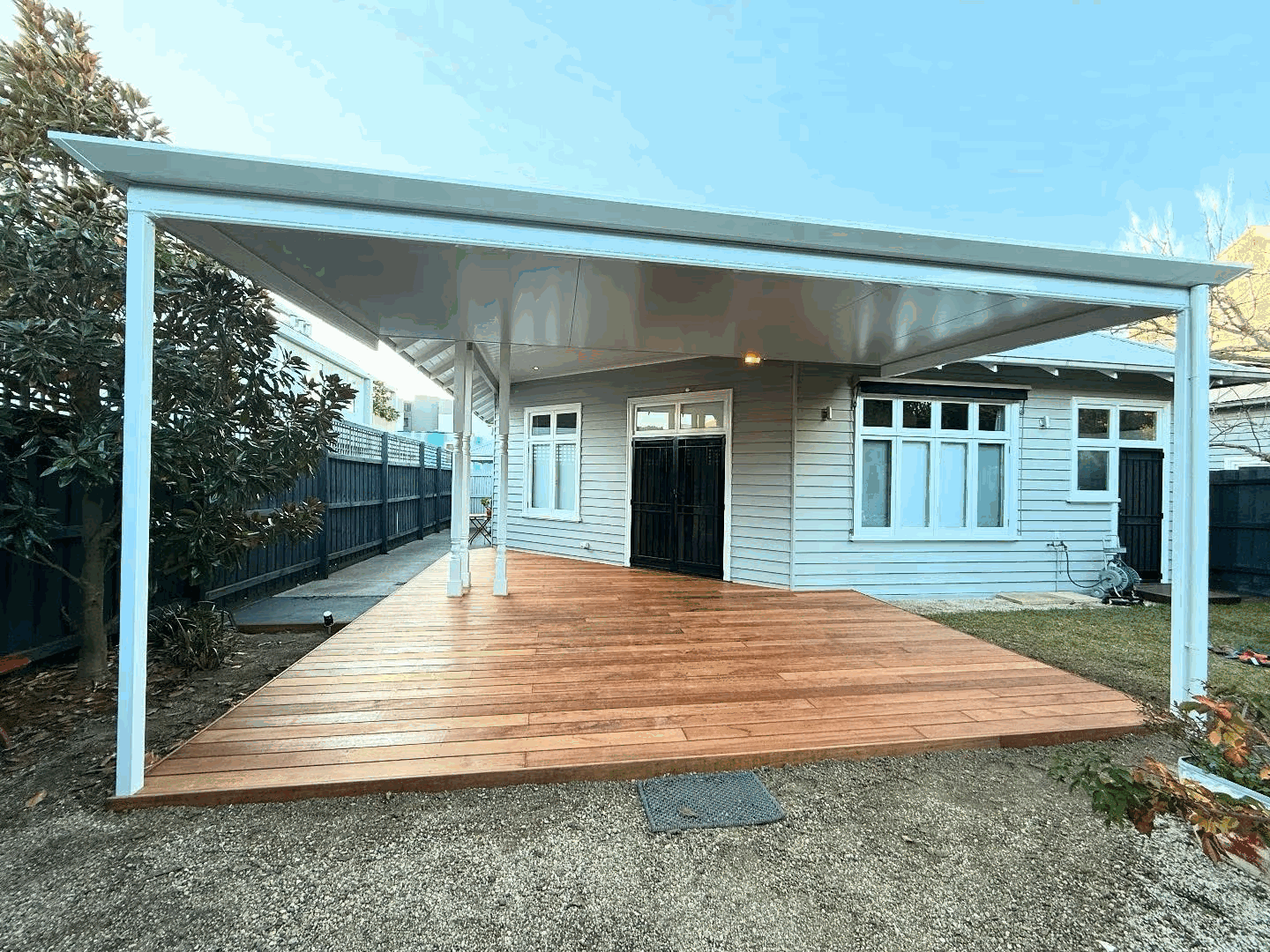 White flat-roof pergola over timber deck on a heritage home, Melbourne
