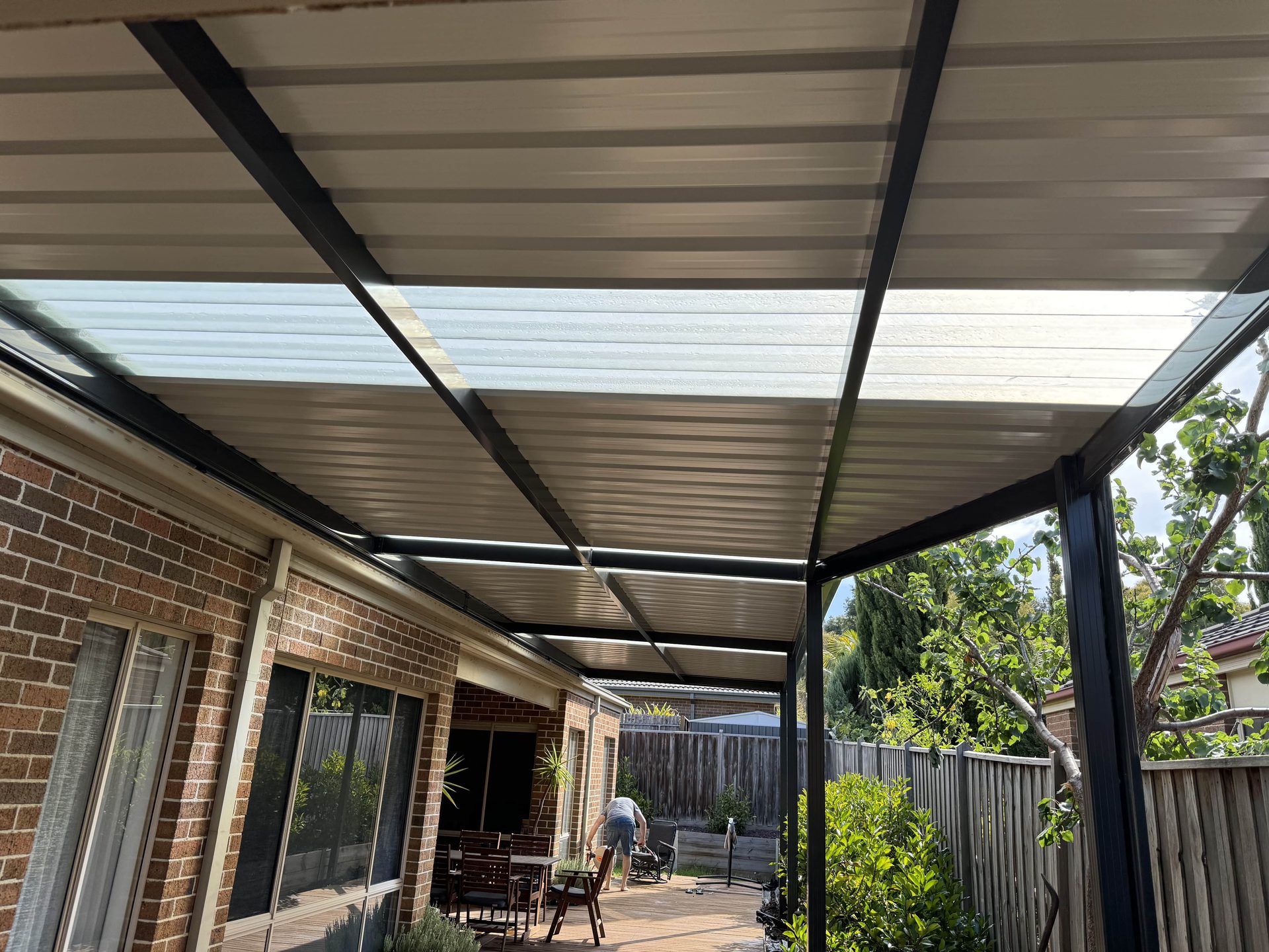 Charcoal-frame pergola with insulated roof over deck, Melbourne